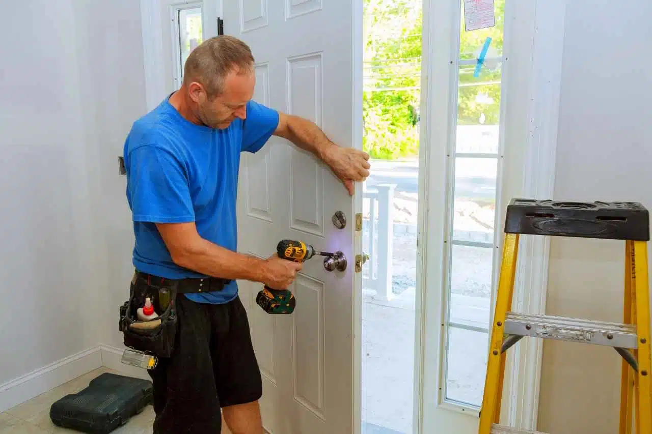 Commercial glass door lock being repaired by technician in Austin TX office building