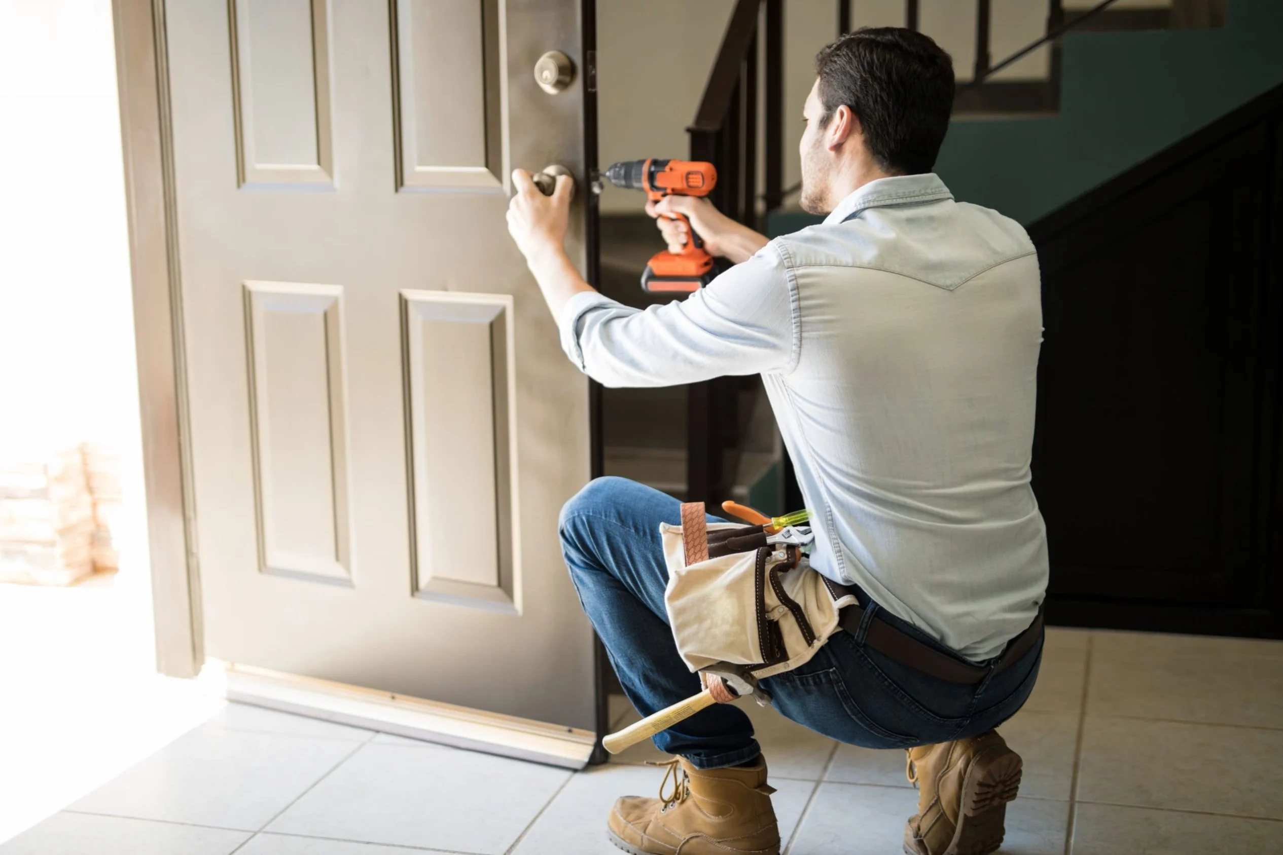 Professional door repair technician repairing a residential entry door in Dallas TX
